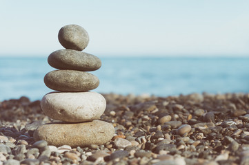 Fototapeta na wymiar Stack Of Balanced Stones On The Beach