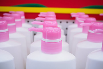 liquid soap in white plastic bottles in supermarket or grocery store