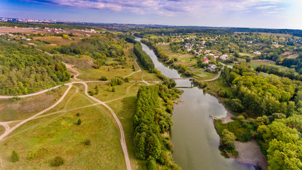 Beautiful view of the forest and the river in the city. Aerial view.