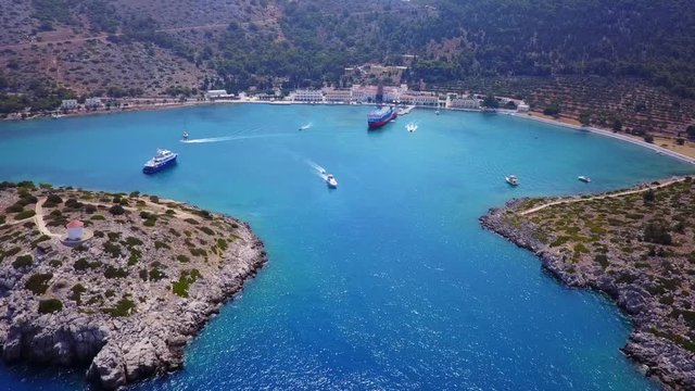 August 2017: Aerial drone video of iconic Archangel Michael of Panormitis bay in island of Symi, Dodecanese, Aegean, Greece