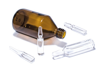 Brown medical vial and ampules on white