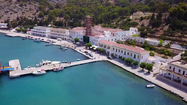 August 2017: Aerial drone video of iconic Archangel Michael of Panormitis bay in island of Symi, Dodecanese, Aegean, Greece