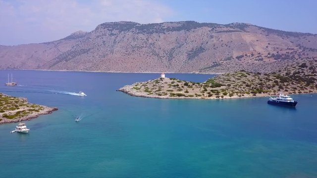 August 2017: Aerial drone video of iconic Archangel Michael of Panormitis bay in island of Symi, Dodecanese, Aegean, Greece