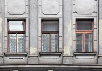 Three Windows on the facade of the gray house