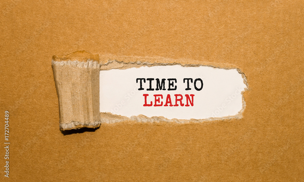 Aufkleber the text time to learn appearing behind torn brown paper