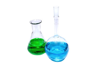 Chemical flasks with green and blue liquid on white background