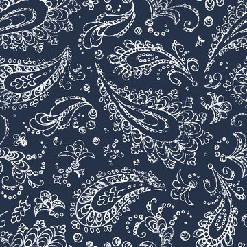 Vintage paisley ornament - seamless pattern. Grunge texture. White flowers, leaves and curls on a blue background. Handmade. Prints for textiles. Bohemian motives.
