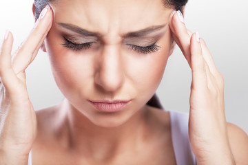 Naklejka premium Depressed overweight is a beautiful young woman with black hair who suffers from severe headaches and a touching head. Migraine. Treatment. The concept of health.