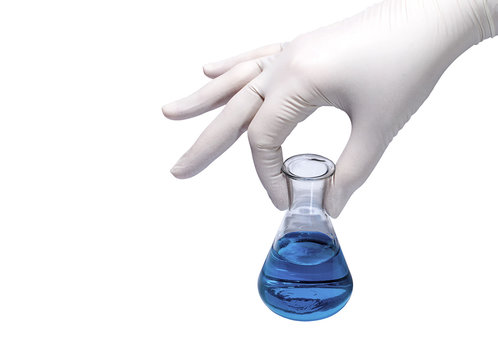 Medical concept: hand in rubber glove holding flask with blue liquid