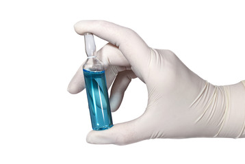 Nurse's hand in medical latex glove with ampule