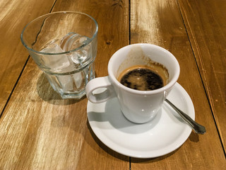 Iced coffee, espresso and a glass of ice cubes