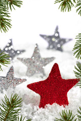 Fototapeta na wymiar Red Christmas star with silver stars on the snow