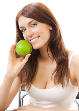 Cheerful woman eating apple, over white