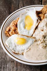 Eggs with grits and country fried chicken