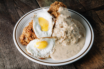 Eggs with grits and country fried chicken