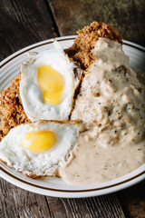 Eggs with grits and country fried chicken
