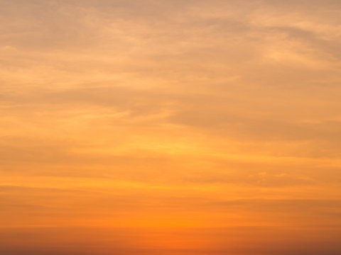 Fototapeta Abstract blur beautiful bright orange and golden sky at sunset sunrise for background.