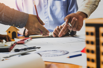 Obraz premium Confident team of architect working together in a office.Then discussing about new startup project on desk. Architect discuss with engineer about project in office, architectural concept