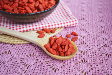 Dry Goji berries in a wooden spoon, healthy food