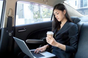 Fototapeta na wymiar Woman using Laptop for working in car with attractive smiling, Woman working concept.