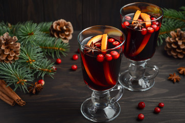 Christmas mulled wine. Holiday concept decorated with Fir branches, Cranberries and Spices.