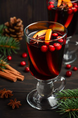 Christmas mulled wine. Holiday concept decorated with Fir branches, Cranberries and Spices.