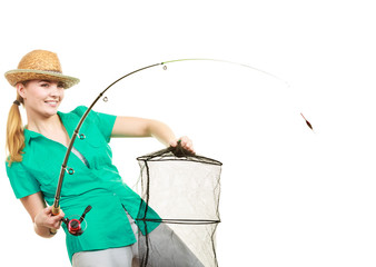 Woman with fishing rod, spinning equipment