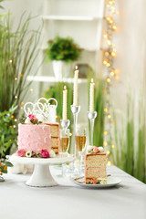 Beautiful wedding cake for lesbian wedding decorated with flowers on table