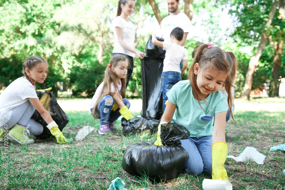 Sticker Young volunteers and children collecting garbage in park