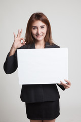 Young Asian woman show OK with white blank sign.