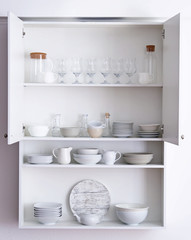 Kitchen cupboard with different clean dinnerware