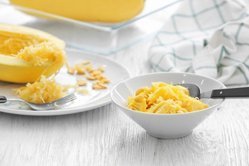 Bowl with flesh of spaghetti squash on table