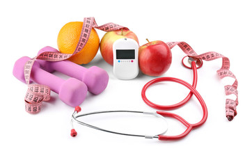 Composition with digital glucometer, stethoscope and dumbbells on white background. Diabetes concept