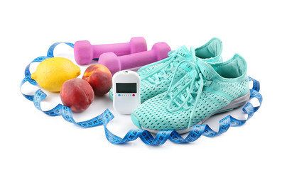 Composition with digital glucometer, fresh fruits and sport inventory on white background. Diabetes concept