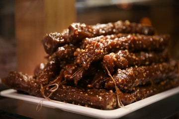 Plate with delicious Turkish dessert churchkhela in cafe