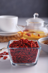 Bowl with dried goji berries on table