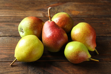 Delicious ripe pears on wooden background