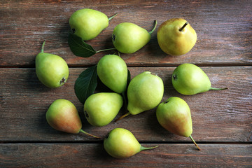 Delicious ripe pears on wooden background