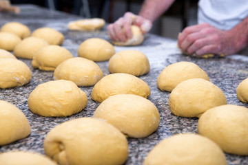 the baker prepares bread dough