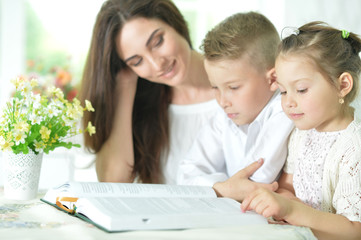 Fototapeta premium Mother and children reading book
