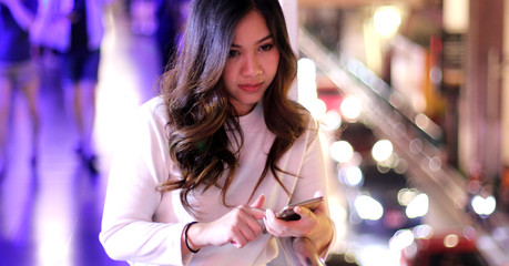 Young asian woman using her mobile phone