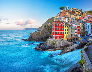 View of the colorful houses along the coastline of Cinque Terre area in Riomaggiore, Italy