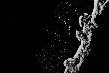 Fototapeta premium White powder isolated on black background, top view