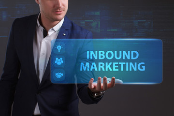 Business, Technology, Internet and network concept. Young businessman working on a virtual screen of the future and sees the inscription: Inbound marketing