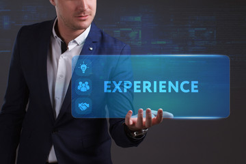 Business, Technology, Internet and network concept. Young businessman working on a virtual screen of the future and sees the inscription: Experience