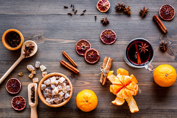 Merry christmas in winter evening with warm drink. Hot mulled wine or grog with fruits and spices on wooden background top view