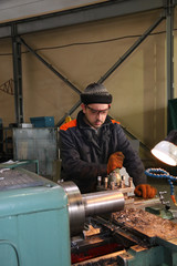 The milling-machine operator works at the lathe