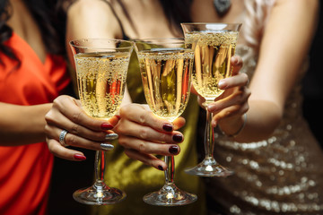Women's hands with glasses of champagne. X-mas.