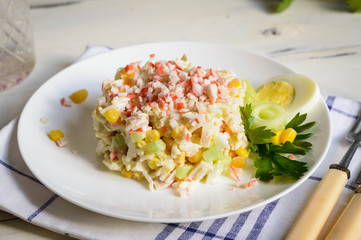 Crab stick salad features rice corn eggs and cucumber