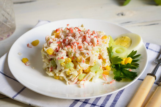 Crab stick salad features rice corn eggs and cucumber